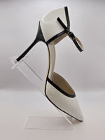 White high-heeled pumps with strap in varnish leather